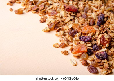 Homemade granola with honey, oatmeal, nuts, raisin, cranberry and dried apricots for background, horizontal