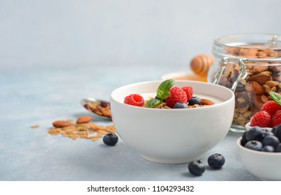 Homemade granola with yogurt and fresh berries, healthy breakfast concept, selective focus. - Powered by Shutterstock