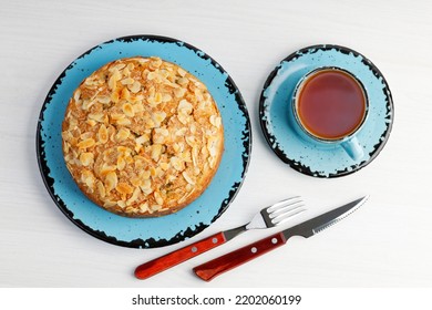 Homemade grape cake and cup of tea on white wooden table. Top view. - Shutterstock ID 2202060199