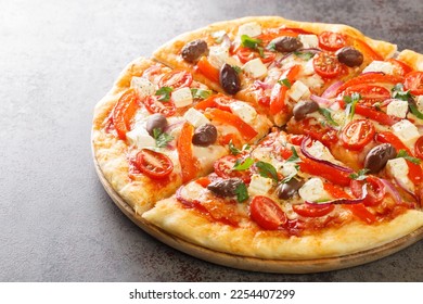 Homemade Greek pizza featuring feta, roasted red peppers, olive, tomato, onions closeup on wooden board on table. Horizontal
 - Powered by Shutterstock