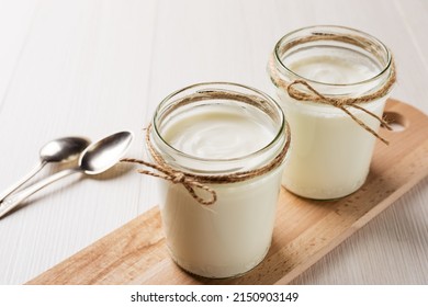 Homemade Greek yogurt in a glass jars ready to eat. Healthy breakfast. - Shutterstock ID 2150903149
