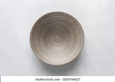 Homemade grey ceramic bowl. Craft ceramics, pottery concept