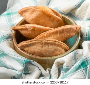 Homemade grilled cheese empanada, on a tablecloth of four. four cheese empanadas on an ando plate - Shutterstock ID 2253718117