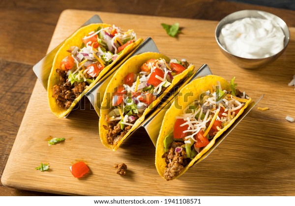 Homemade Ground Beef Hard Shell Tacos with Lettuce\
and Tomato