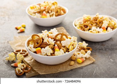 Homemade Halloween Trail Or Snack Mix With Candycorn, Popcorn, Pretzels And Nuts In White Bowls