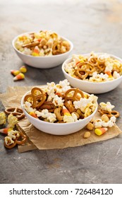 Homemade Halloween Trail Or Snack Mix With Candycorn, Popcorn, Pretzels And Nuts In White Bowls