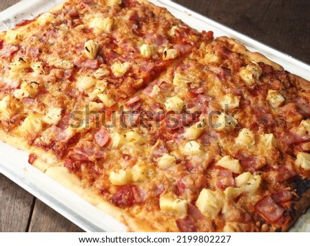 homemade ham and pineapple pizza in rectangle shape