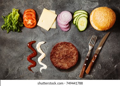 Homemade Hamburger With Ingredients On Dark Slate Background Top View