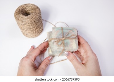 Homemade Handmade Soap. Sandalwood Scent, Female Hands And Jute Twine. Small Business, Organic Products, Natural Ingredients. Top View.