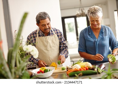 Homemade Happiness. Shot Of A Happy Senior Couple Cooking A Healthy Meal Together At Home.