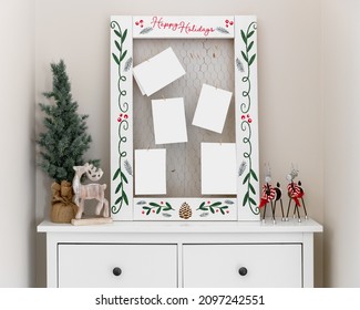 A Homemade Happy Holidays Card Holder On A Dresser Surrounded By Christmas Decorations And Holding Blank Cards.