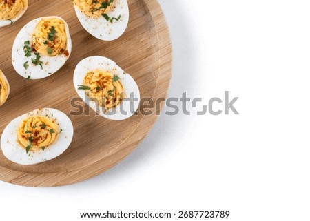 Homemade hard Boiled Deviled Eggs garnished with herbs isolated on white background. Top view. Copy space