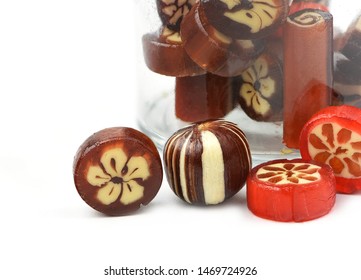 Homemade Hard Sugar Candy,boiled Sweet With Small Glass Jar As Background Isolated On White 