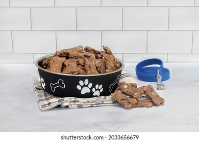 Homemade, Healthy Blueberry Dog Cookies On A Counter And In A Dog Bowl With A Leash On The Side.