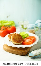 Homemade Healthy Fish Cakes With Green Salad And Fresh Tomato