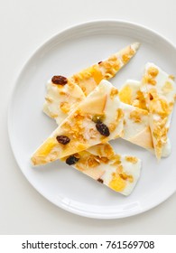 Homemade Healthy Frozen Muesli Yogurt Bark With Orange And Apple, Top View