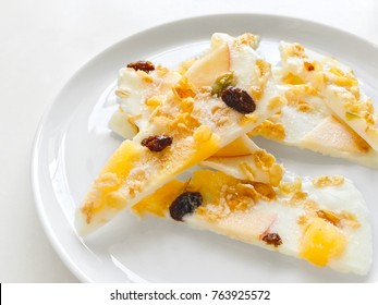 Homemade Healthy Frozen Muesli Yogurt Bark With Orange And Apple, Close Up