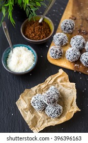 Homemade Healthy Paleo Raw Chocolate Truffles with Nuts, Dates and Coconut Flakes, Vertical