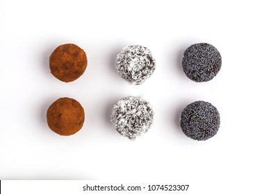 Homemade Healthy Raw Energy Balls with carob, a poppy and coconut isolated on white background, top view