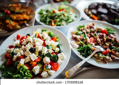 Homemade Healthy Salad Buffet.Special Occasion Catering.Celebration Dinner.Mediterranean Seafood And Octopus Salad With Onions,olive Oil,olives And Capers.Greek Salad With Feta Cheese Side Dish