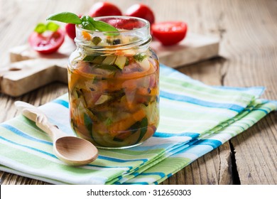 Homemade Healthy Vegetable  Preserves In Glass Jar, Zucchini, Carrots, Onions And Tomatoes Salad