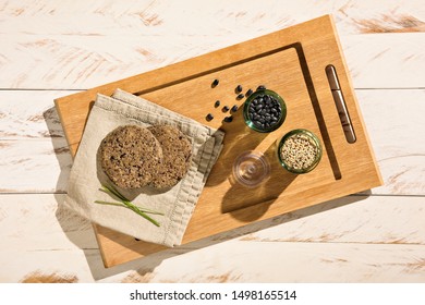 Homemade Healthy Vegetarian Quinoa And Black Bean Burger On A Wood Tray, Shot From Above With Ingredients Aside