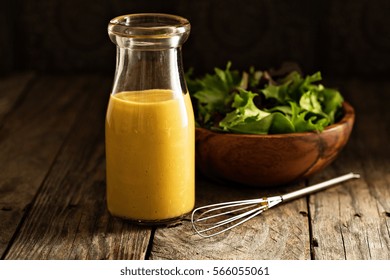 Homemade Honey Mustard Salad Dressing In Glass Bottle.