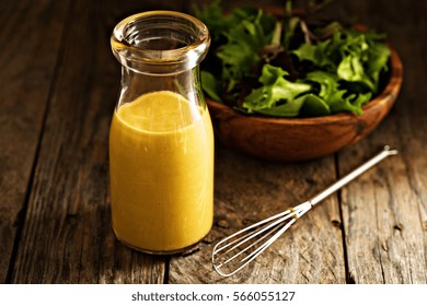 Homemade Honey Mustard Salad Dressing In Glass Bottle.