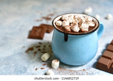 Homemade hot chocolate with mini marshmallow in a blue enamel mug on a light slate background.Rustic style. - Powered by Shutterstock