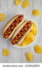 Homemade Hot Dog With Ketchup And Yellow Mustard With Chips On A Plate, Top View. Flat Lay, Overhead, From Above.