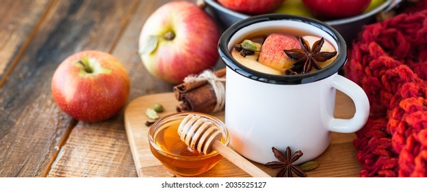 Homemade Hot Fruit Tea With Fresh Apples, Honey, Spices: Cinnamon, Cardamon, Anise, Clove. Warm Autumn Drink, Delicious Healthy Beverage. Mulled Wine. Cozy Home Atmosphere. Wooden Background. Banner