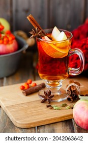 Homemade Hot Fruit Tea With Fresh Apples, Honey, Spices: Cinnamon, Cardamon, Anise, Clove. Warm Autumn Drink, Delicious Healthy Beverage. Mulled Wine. Cozy Fall Home Atmosphere. Wooden Background