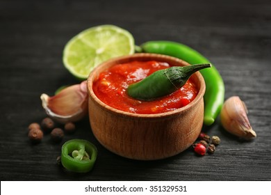 Homemade Hot Sauce And Spices On Dark Wooden Background