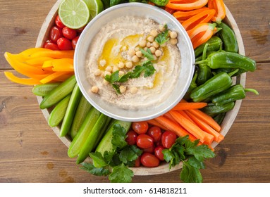 Homemade hummus with olive oil and fresh vegetables