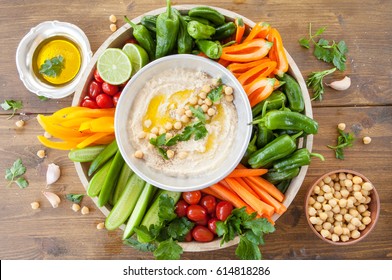 Homemade hummus with olive oil and fresh vegetables