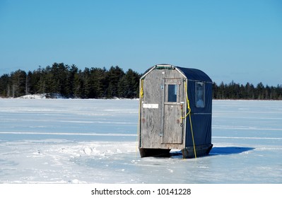 Home-made Ice Fishing Shack On A Frozen Lake.