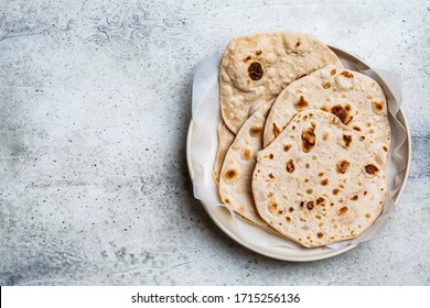 Homemade indian pita chapati on a gray background. Vegetarian cuisine concept.