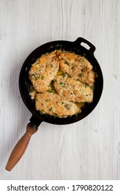 Homemade Italian Chicken Piccata In A Cast Iron Pan, Top View. Overhead, From Above, Flat Lay. 