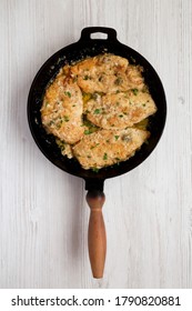 Homemade Italian Chicken Piccata In A Cast Iron Pan, Top View. Overhead, From Above, Flat Lay. 