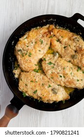 Homemade Italian Chicken Piccata In A Cast Iron Pan, Top View. Overhead, From Above, Flat Lay. 