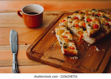 Homemade Italian Focaccia, with tomato and olive oil on a rustic - Powered by Shutterstock