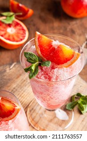 Homemade Italian Granita Dessert With Blood Orange, Elderflower, Rose Wine  In Serving Glasses On A Wooden Tray On A Wooden Table.