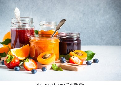 Homemade jam in glass jars at white table. - Shutterstock ID 2178394967