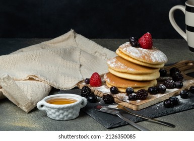 homemade japan sweet pancake dressed with strawberries,berries,sugar and dark background.
