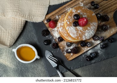 homemade japan sweet pancake dressed with strawberries,berries,sugar and dark background.