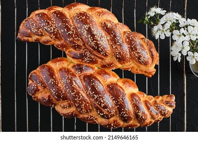 Homemade Jewish Challah Bread, Top View. From Above, Overhead. Sweet Holiday Bread Sprinkled With Sesame Seeds Cools Down After Baking, Flat Lay