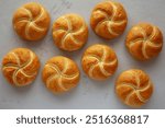 Homemade Kaiser Rolls on a wooden board, top view. 