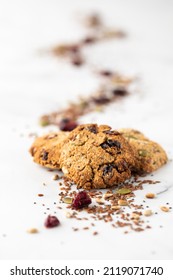 Homemade Ketogenic Trail Mix Cookies With A Trail Of The Mix In Behind.