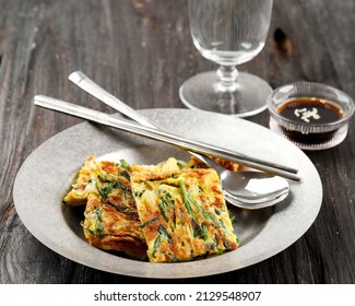 Homemade Korean Pajeon Scallion Pancakes with Soy Sauce and Sesame Seed  on a rustic Grey Plate on a Wooden Table. Asian food. Close-up.