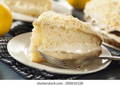 Homemade Lemon Cake With Cream Frosting On A Background